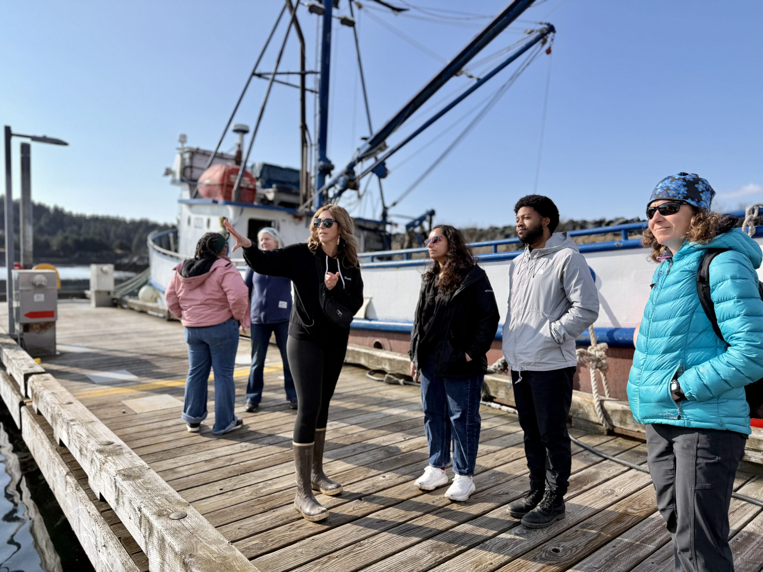 Danielle Ringer, ADM member from Kodiak, giving Carbon180 team members a rundown of the Kodiak harbor.