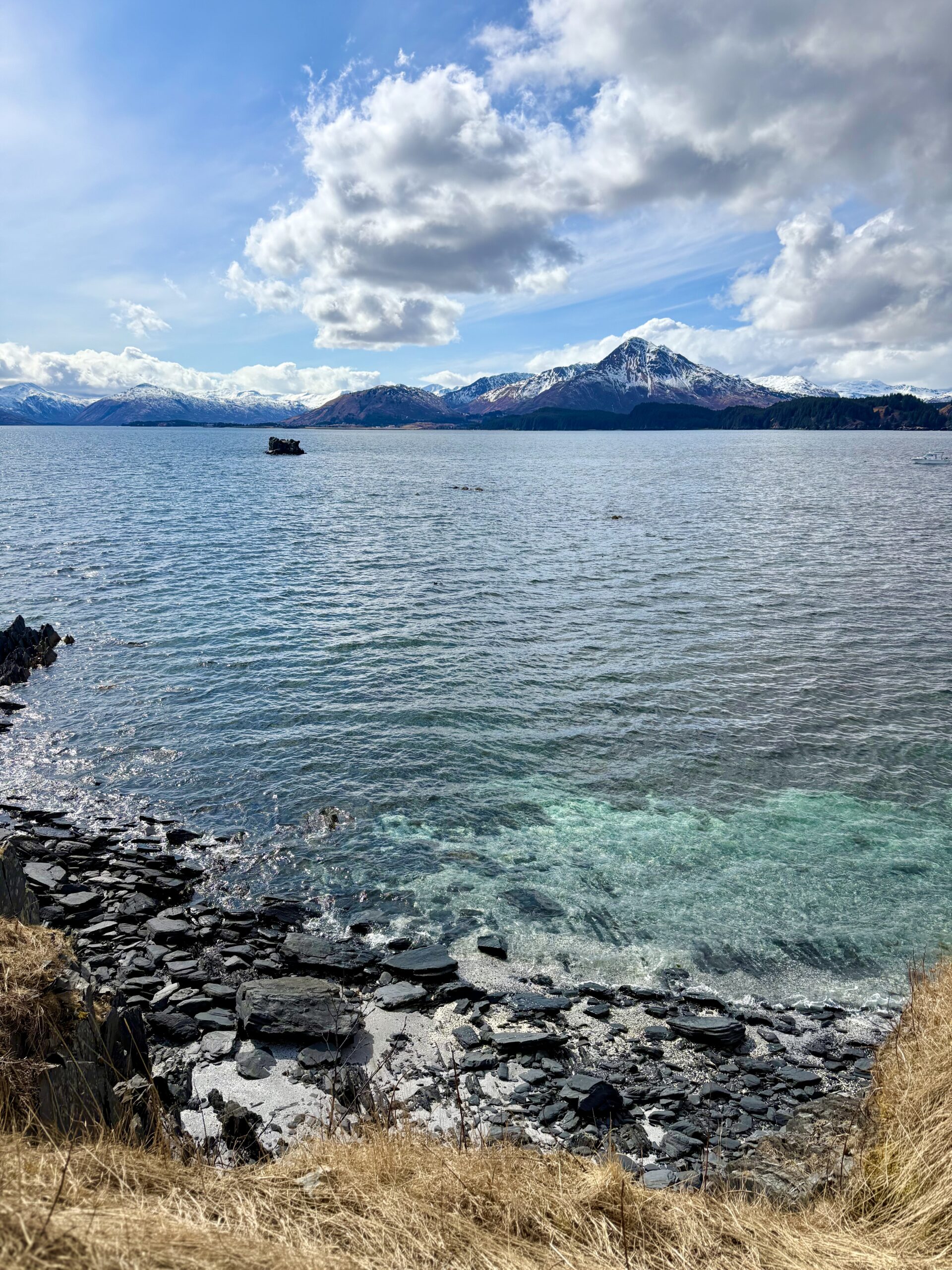 Snow capped mountains across from the bay at Kodiak Station.