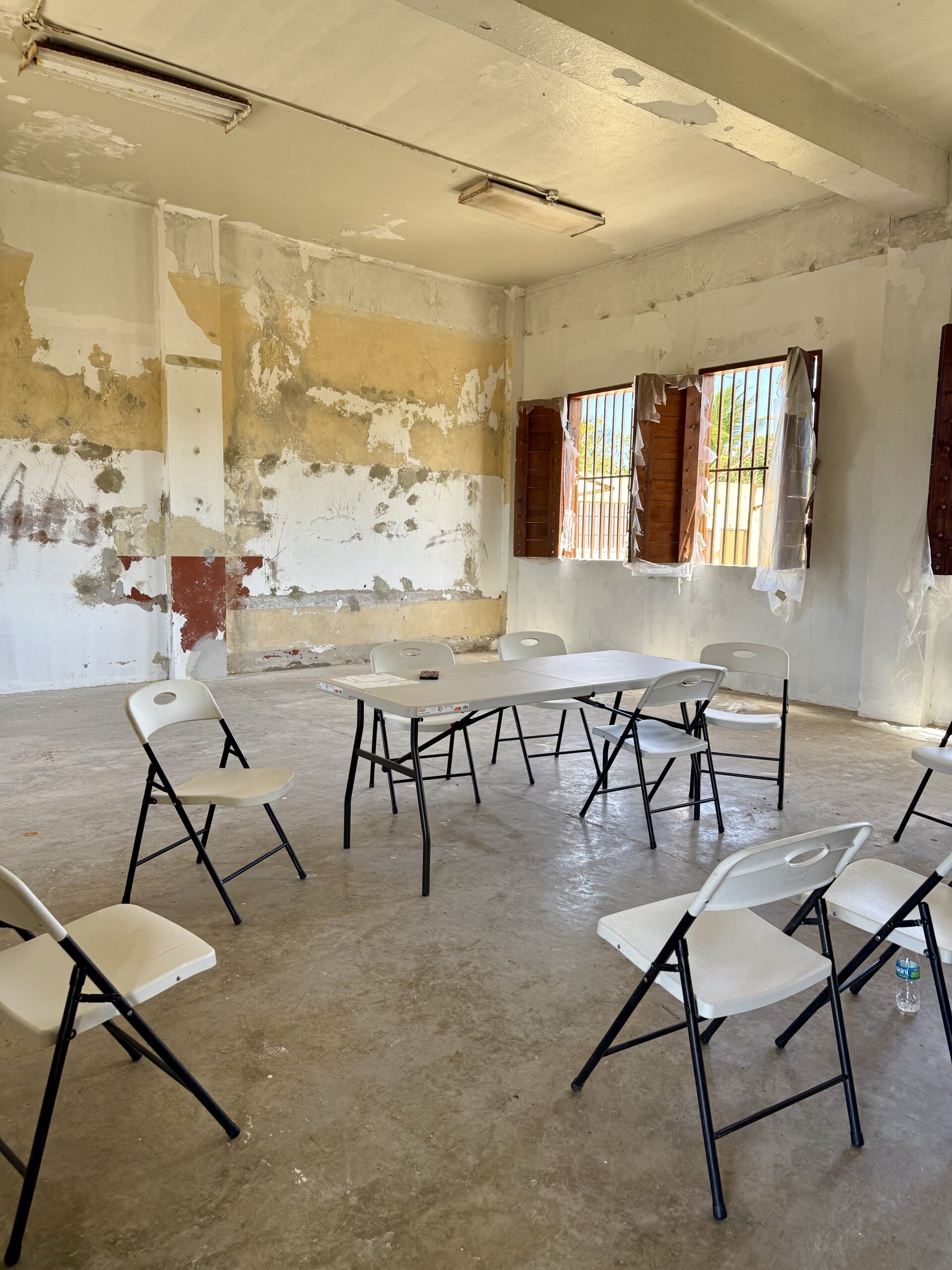 A circle of chairs where elder residents gather to plan the next phase of reopening a school that was hit by the storms