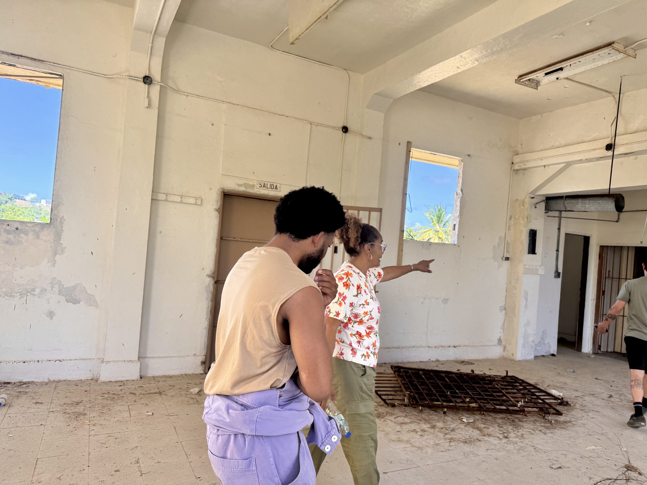A resident showing where damage occurred to the school and what will be fixed